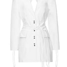 Vaska denim white jean jacket dress hanging on a hanger, showing long sleeves and classic jacket style, size XS.