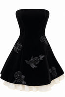 Black URBAN MUSE Velours mini dress displayed on a hanger, showcasing its soft velvet fabric and stylish mini length.