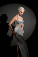HACCHIC COUTURE Lunara Crystal Halter Gown featuring elegant crystal embellishments and flowing fabric on a formal dress display.