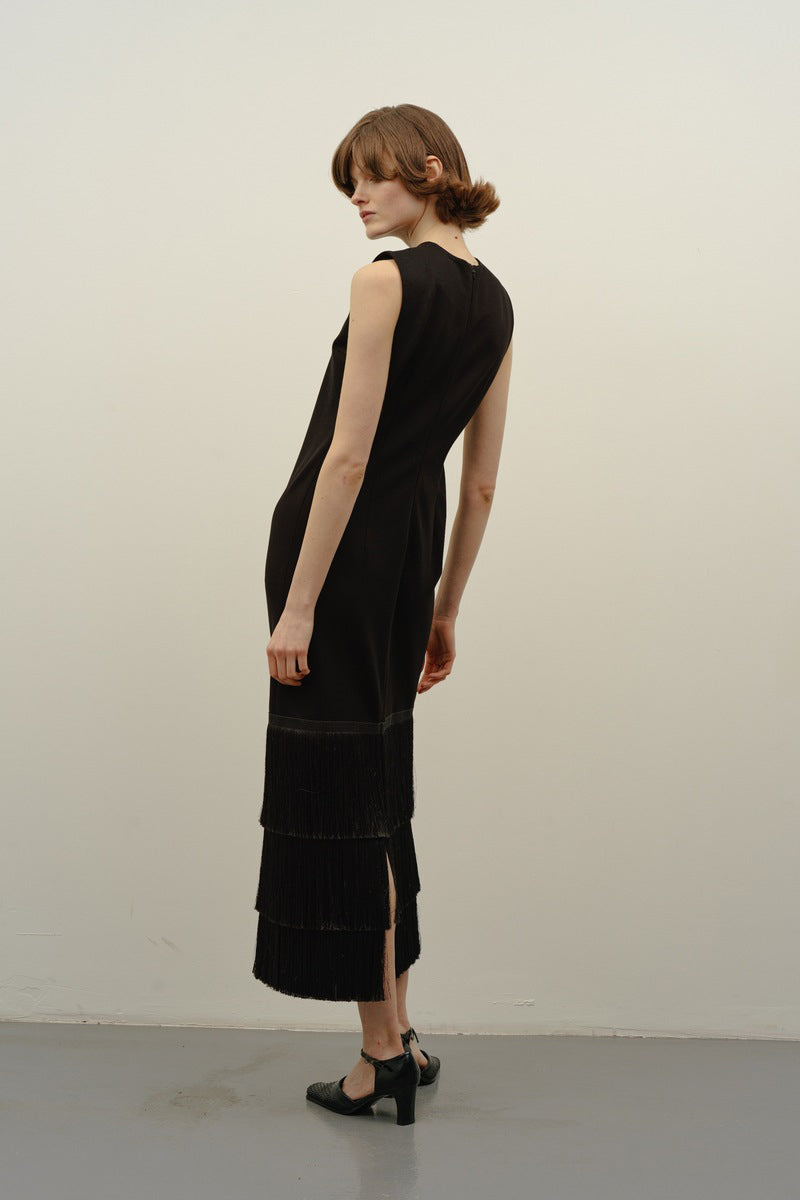Back view of DELEGAN BAKHROMA black midi dress, showcasing its fitted silhouette and elegant design.