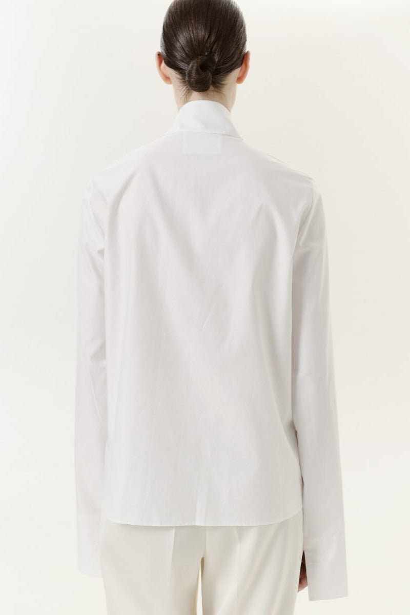 DELEGAN Still Line Shirt displayed from the back, featuring a modern, minimalist design with a relaxed fit and subtle detailing.