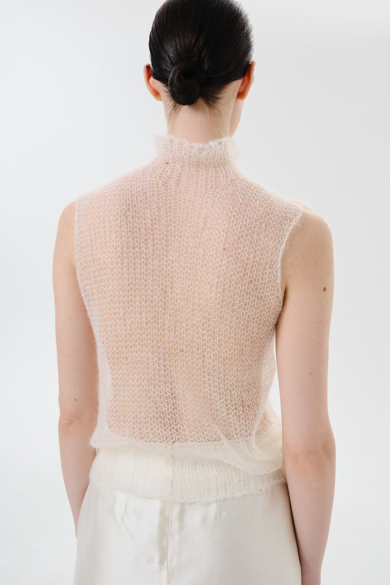 Back view of DELEGAN soft skin sheer knit top, lightweight and fitted women's top with a delicate, semi-transparent fabric.