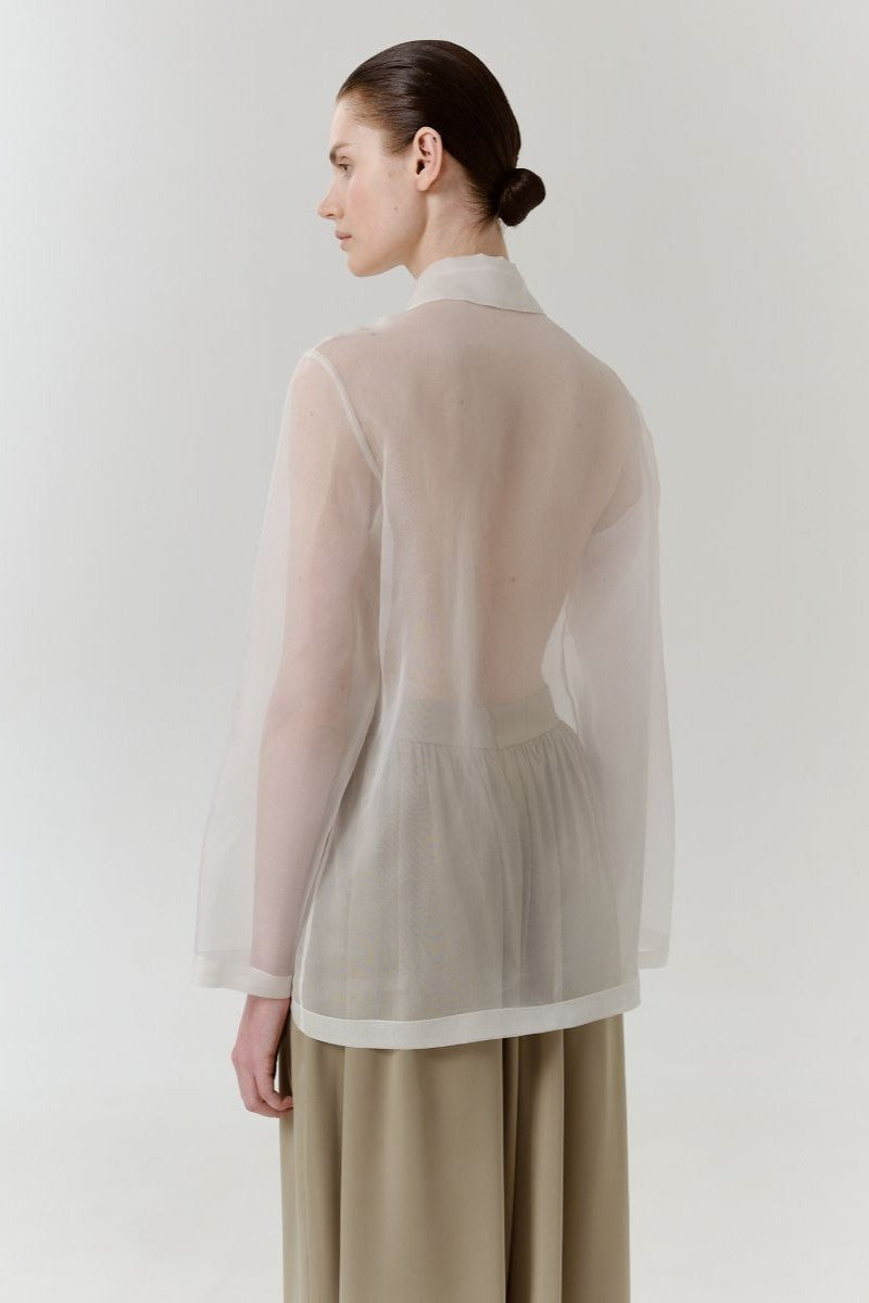Red Delegate silk shirt shown from the back, featuring a sleek design and smooth silk fabric for a stylish look.