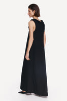 DELEGAN KOSSA maxi dress shown from the back, featuring flowing fabric and elegant design in a stylish maxi dress style.
