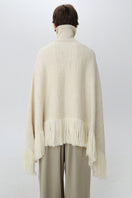 Back view of a DELEGAN Milk Blush Cardigan poncho, showcasing its soft fabric and relaxed, cozy fit.