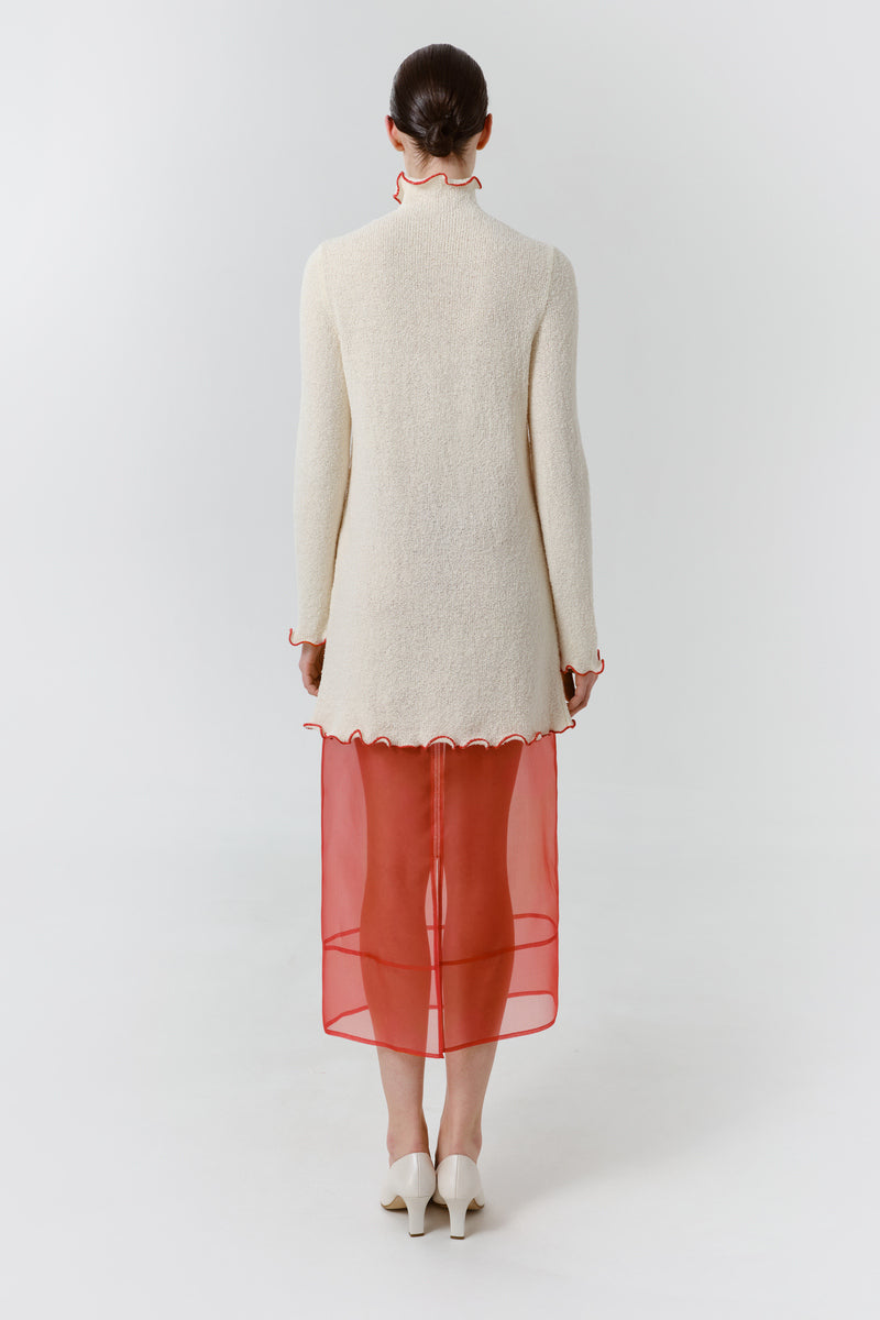 Red blush midi dress by DELEGAN, shown from the back with a flowing silhouette and elegant design.