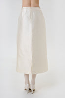 Back view of a DELEGAN velvet blush silk midi skirt showcasing smooth fabric and elegant drape on a model.