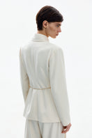 White and gold DELEGAN belted jacket displayed from the back, showcasing its stylish design and detailing.