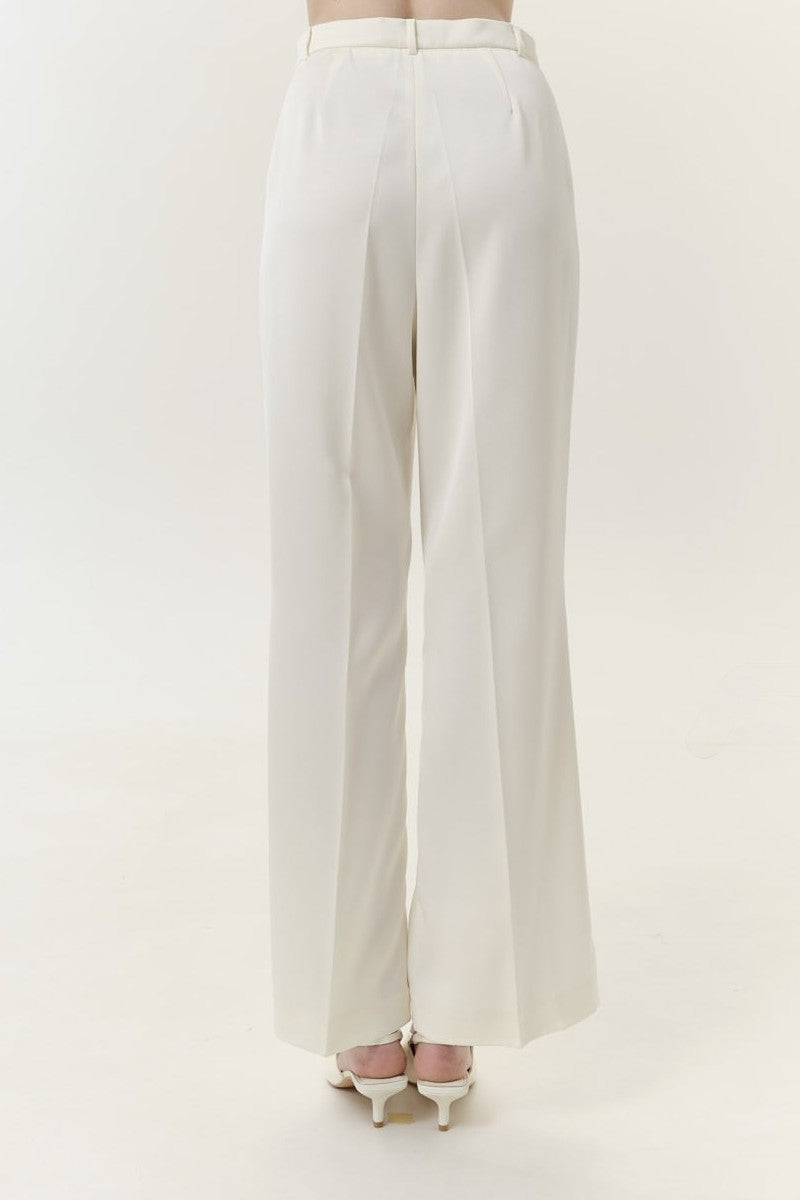 Ivory satin pants with belt from DELEGAN, shown from the back, featuring smooth fabric and stylish waist detail.