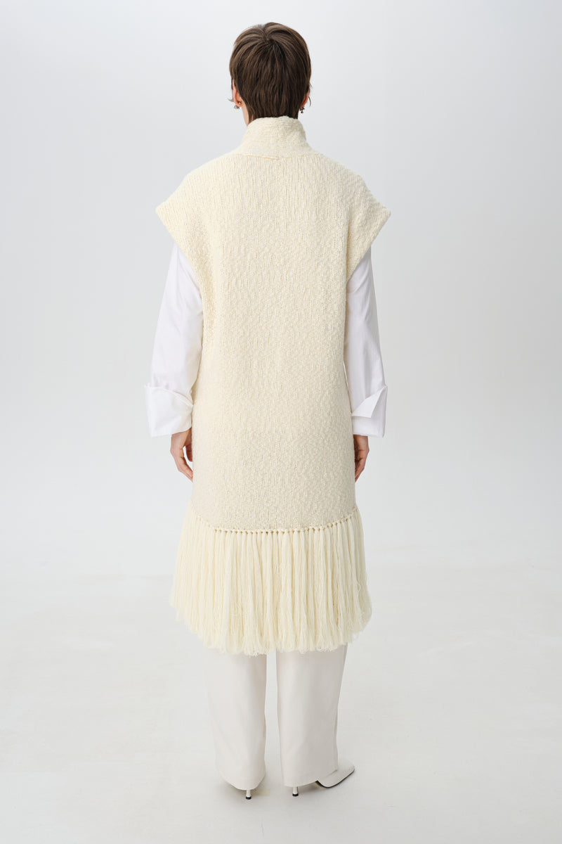Textured knit vest cardigan by DELEGAN, shown from the back, featuring a cozy, patterned knit design and fitted style.