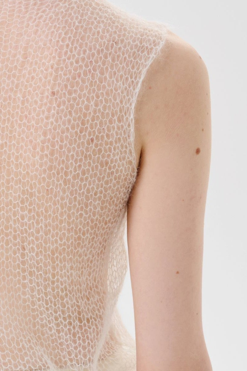 Back view of DELEGAN soft skin long sheer knit top, lightweight and flowy, worn as a stylish women's long sleeve knit blouse.