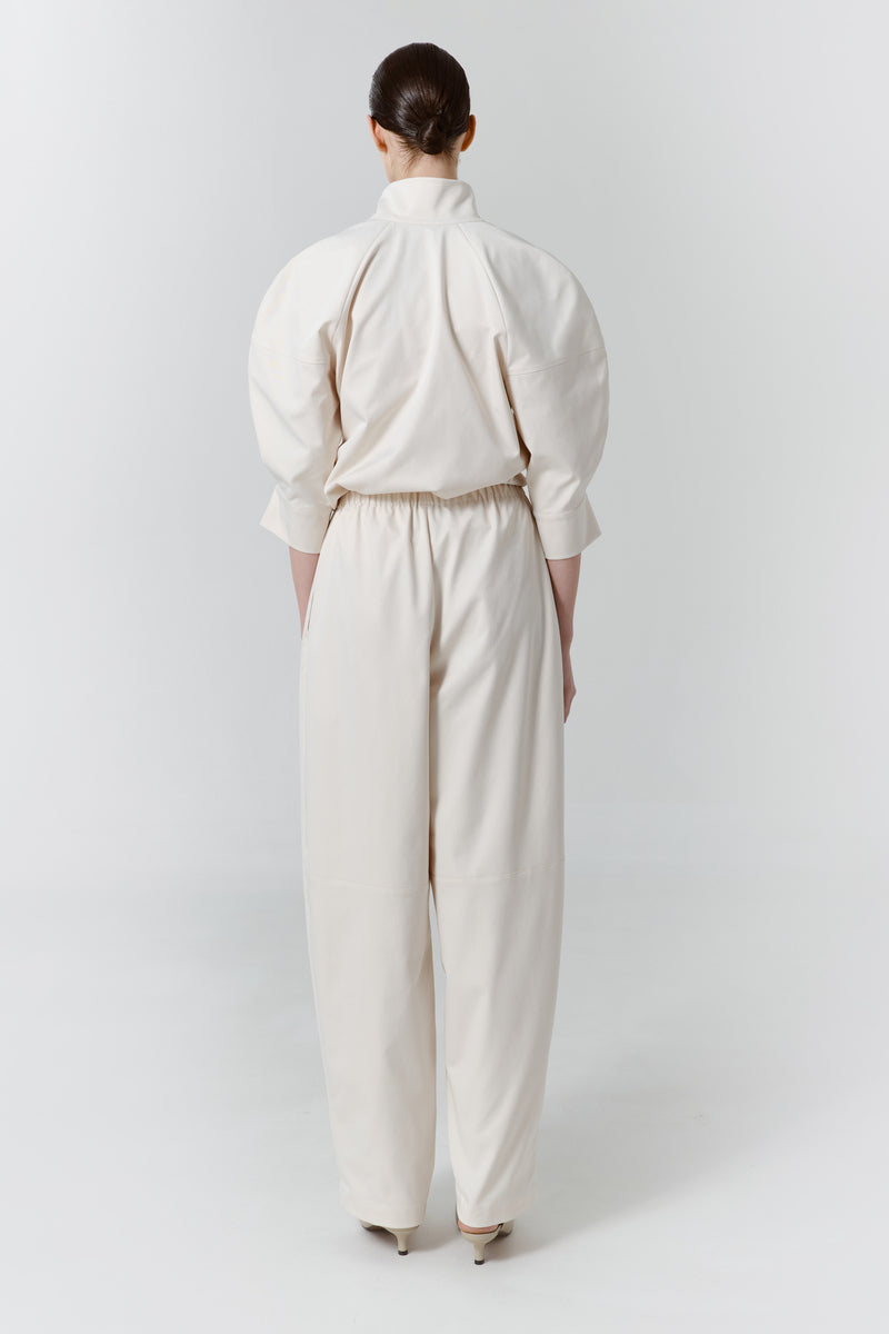 Back view of DELEGAN gray-beige structure pants showing tailored fit and clean lines.