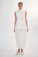 Front view of the DELEGAN structural milk-colored top, showcasing its stylish design and fit.