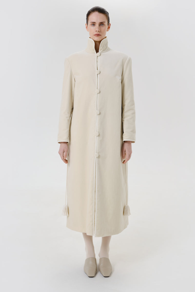 Ivory velvet coat by Delegan displayed on a model, showing the front view with a stylish collar and tailored fit.