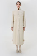 Ivory velvet coat by Delegan displayed on a model, showing the front view with a stylish collar and tailored fit.