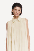 Warm ivory shirt scarf with silk fringe from DELEGAN, shown worn around the neck with soft fabric and elegant detailing.