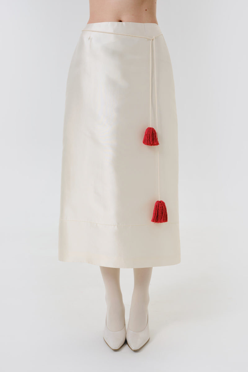 DELEGAN velvet blush silk midi skirt worn front view, showcasing soft fabric and elegant design.