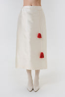 DELEGAN velvet blush silk midi skirt worn front view, showcasing soft fabric and elegant design.