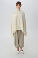 DELEGAN Milk Blush Poncho cardigan worn front view, soft knit fabric, cozy and stylish for casual wear.
