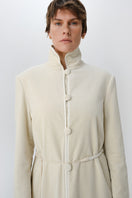 Ivory velvet coat by Delegan displayed on a model, showing the front view with a stylish collar and tailored fit.