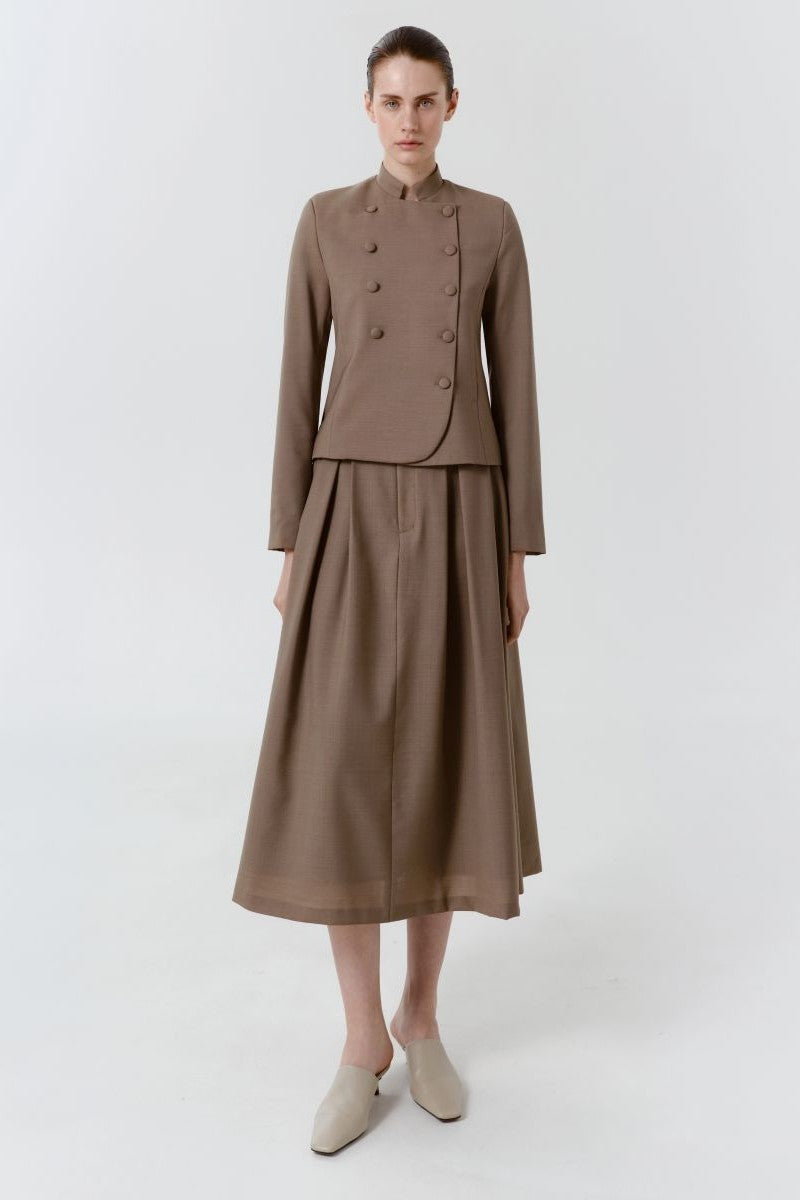 Delegan wool midi skirt displayed on a model, featuring a classic A-line design in cozy, textured wool fabric.