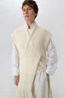 Textured knit vest from DELEGAN, styled as a cardigan, showing the front with a cozy, patterned knit design.
