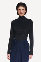 Black tie neck blouse by Delegan, front view showing sleek fabric, classic collar, and elegant design for stylish shirts.
