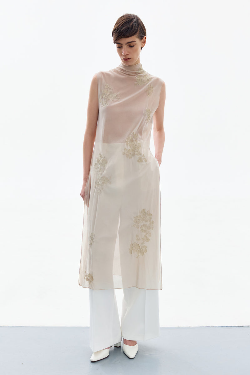 Front view of a brass floral midi dress from DELEGAN featuring a fitted bodice and flowing skirt.