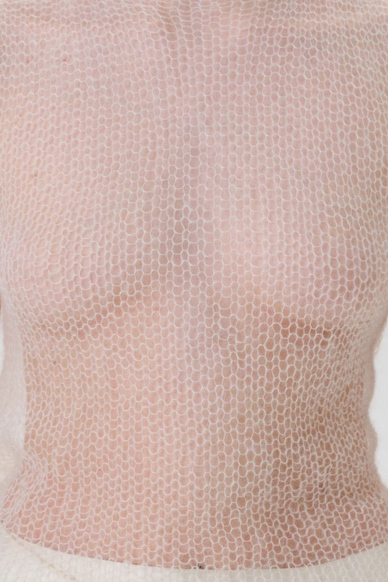 DELEGAN soft skin long sheer knit top worn front, lightweight, semi-transparent fabric, long sleeves, fitted style.
