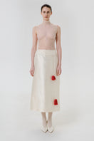 DELEGAN velvet blush silk midi skirt shown from the front, featuring a smooth, flowing fabric and elegant design.