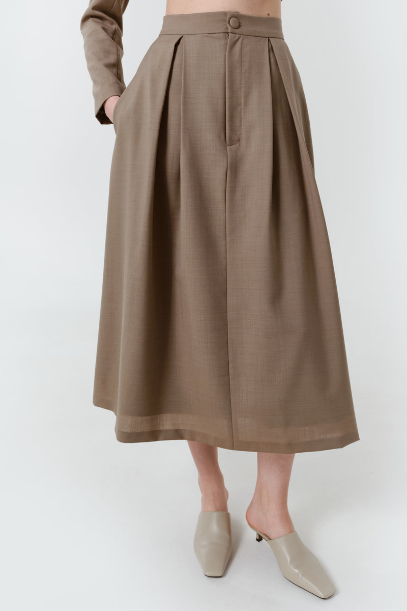 DELEGAN wool midi skirt shown from the front, featuring a sleek, fitted design in soft, warm fabric perfect for stylish fall outfits.