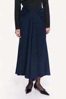 Midnight blue DELEGAN midi skirt displayed from the front, showing its sleek, flowing fabric and stylish length.