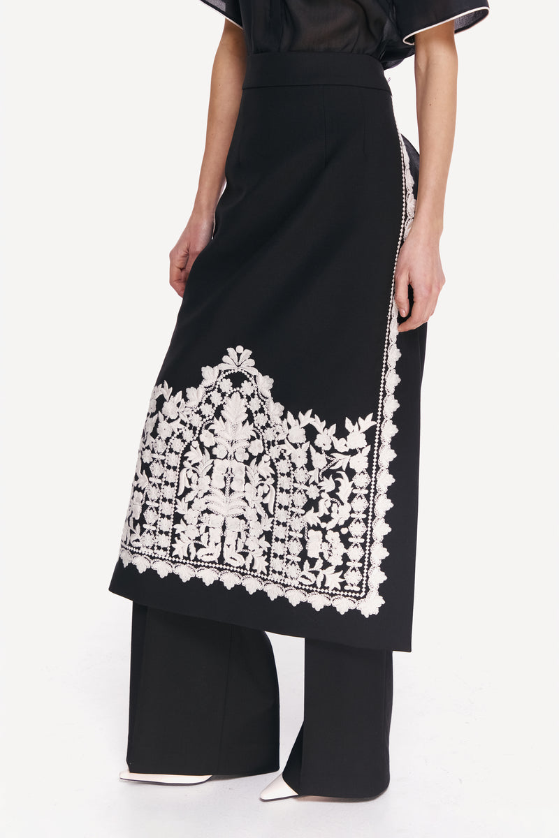 Delegan PLAKHTA filigree midi skirt shown from the front, featuring intricate lace detailing and a flowing silhouette.