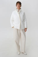 White DELEGAN jacket shown from the front, featuring a stylish and sleek design with a zip-up closure and modern fit.