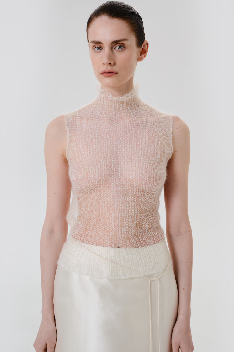 DELEGAN soft skin sheer knit top worn front view, lightweight and fitted women's top with a delicate, transparent fabric for casual wear