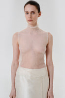 DELEGAN soft skin sheer knit top worn front view, lightweight and fitted women's top with a delicate, transparent fabric for casual wear