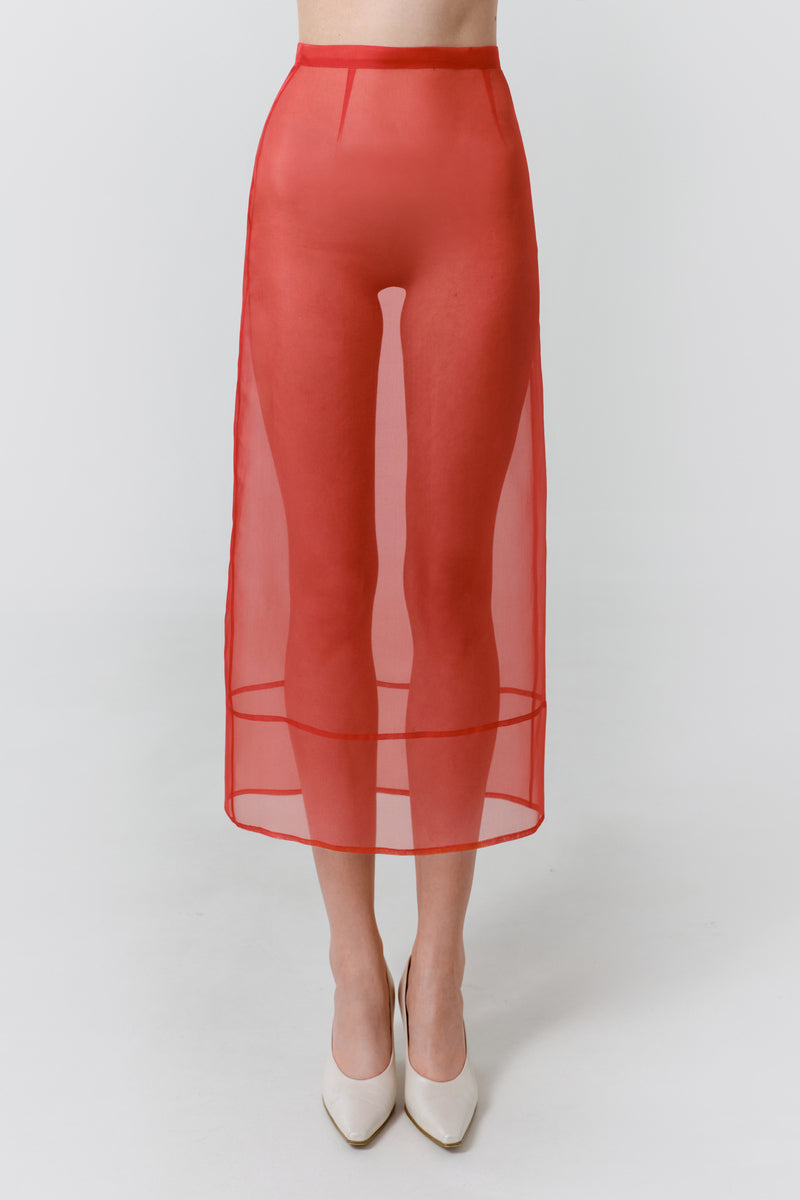 Red veil midi skirt by DELEGAN, shown worn front view, featuring flowing fabric and stylish design.