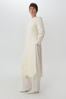 Worn side view of DELEGAN statement wool midi dress, showcasing its stylish fit and textured fabric.