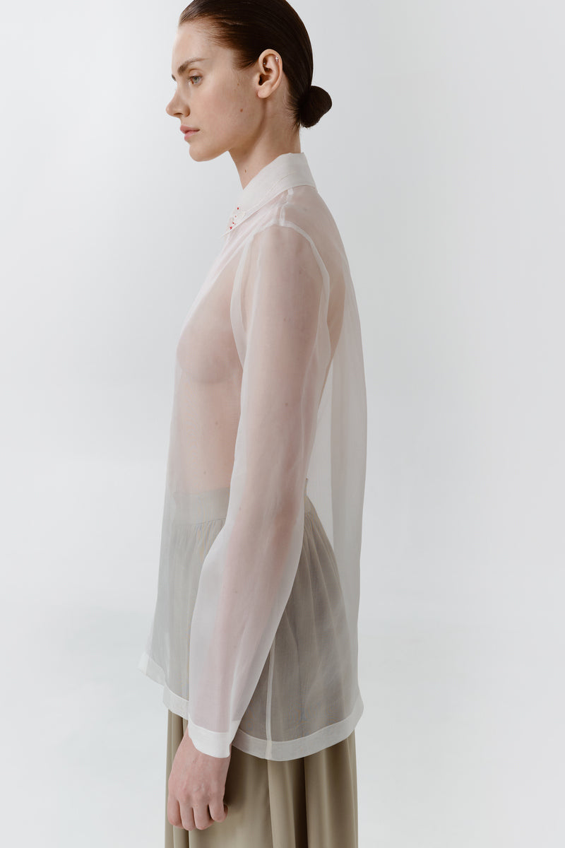 Red Delegan Trace Silk Shirt displayed on a person, showcasing its elegant fit and smooth silk fabric.