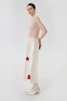 Side view of a DELEGAN velvet blush silk midi skirt featuring a smooth, flowing fabric and elegant silhouette.