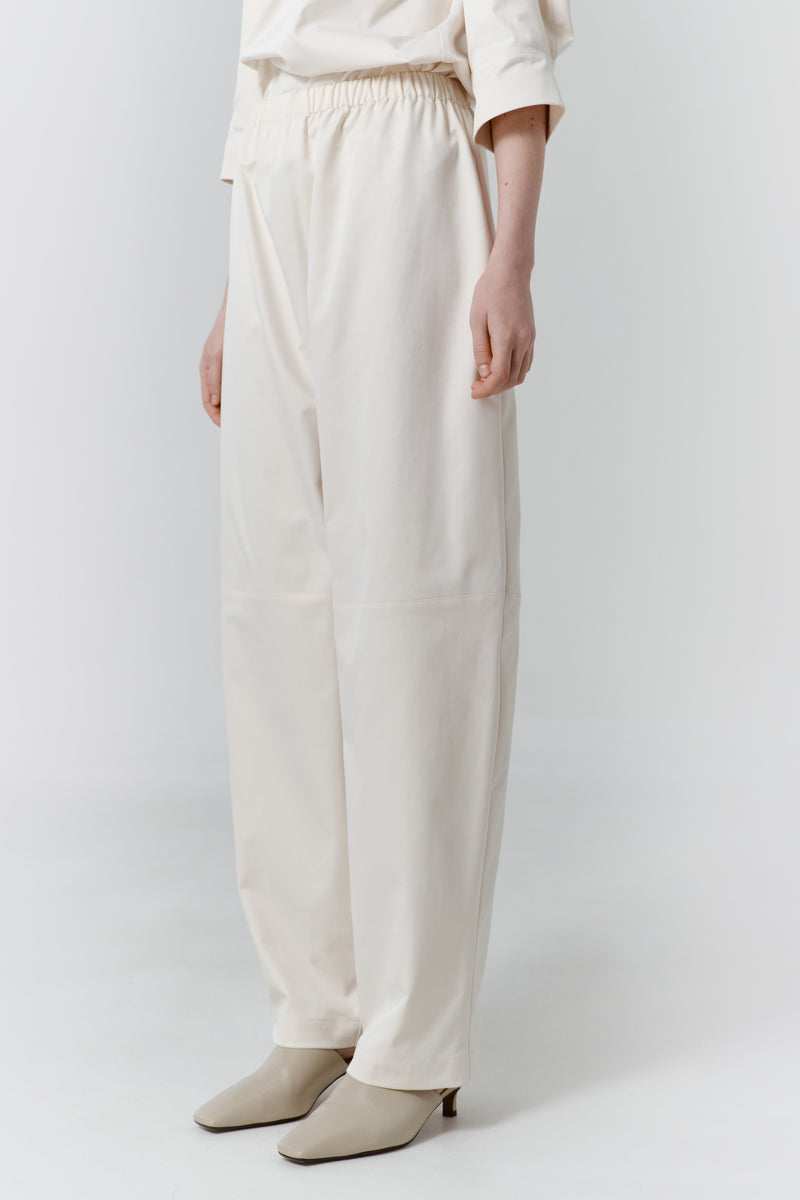 Gray-beige structure pants by DELEGAN, shown from the side, featuring tailored fit and modern design details.