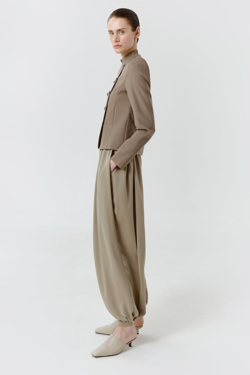 DELEGAN Olive Flow Pants shown from the side, featuring relaxed fit and lightweight fabric for casual wear.