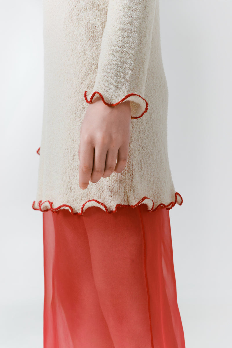 Red veil midi skirt by DELEGAN, shown from the side with flowing fabric and stylish design.