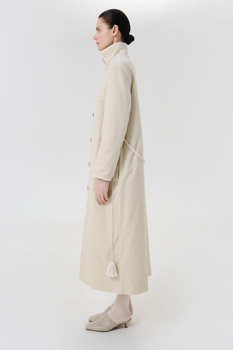 Ivory velvet coat by Delegan shown on a model, featuring a luxurious texture and tailored fit.