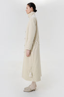 Ivory velvet coat by Delegan shown on a model, featuring a luxurious texture and tailored fit.