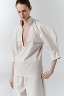 Gray-beige structure shirt by DELEGAN, shown from the worn side, featuring a tailored fit and subtle textured fabric.