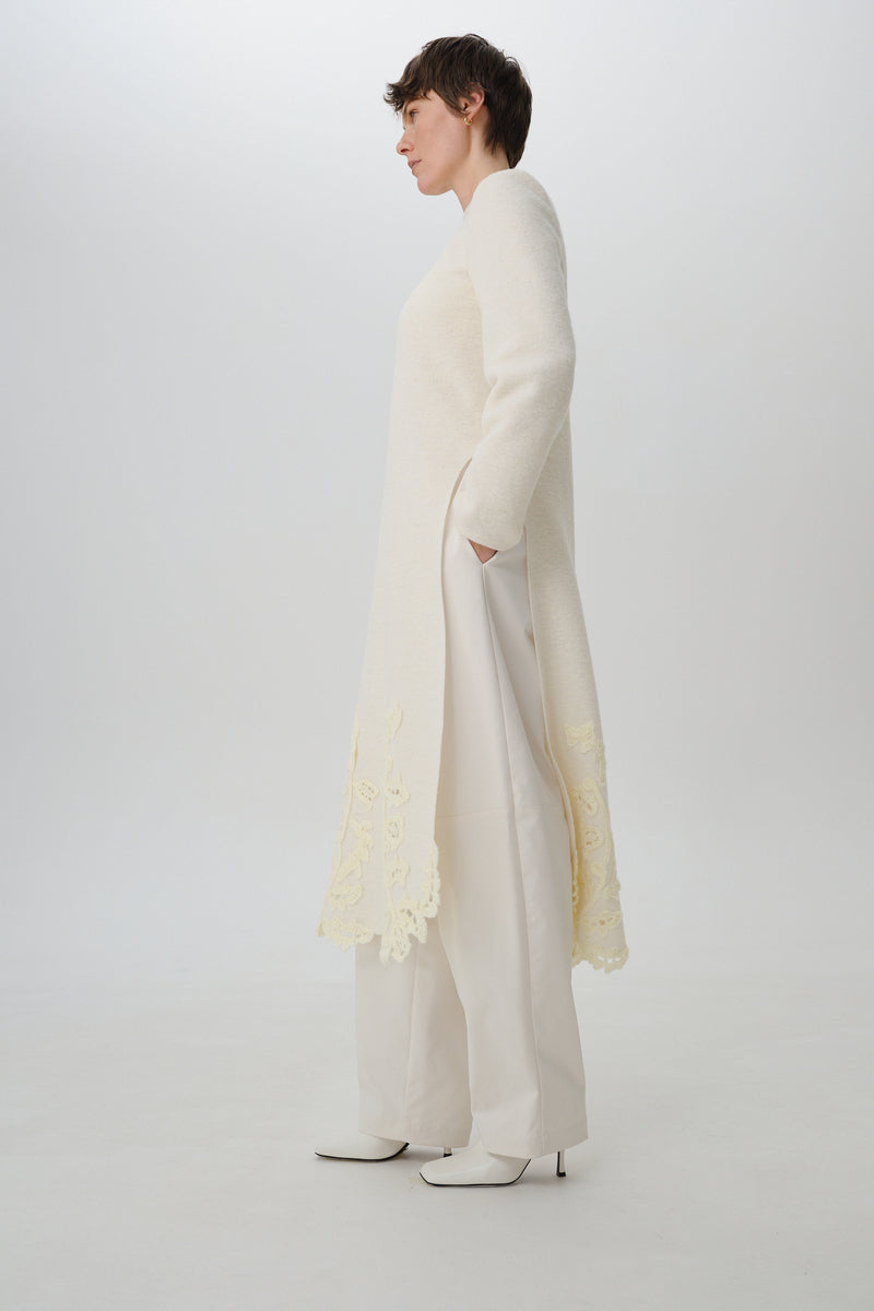 Worn side view of DELEGAN statement wool midi dress showcasing its stylish fit and texture.