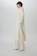 Worn side view of DELEGAN statement wool midi dress showcasing its stylish fit and texture.