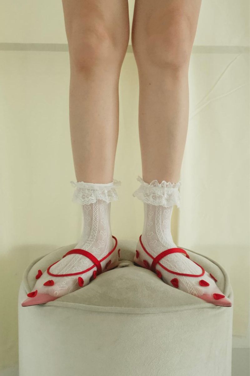 Christin Wu Wynne Flats featuring pointed toes, sleek design, and stylish black leather material.