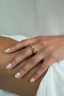 Gold-plated silver NOVA ring with colorful gemstones and enamel details on a female hand.